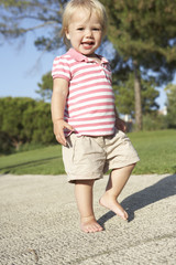 Fototapeta premium Little Girl Walking In Park