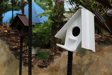 Wooden bird houses on rebar steel.