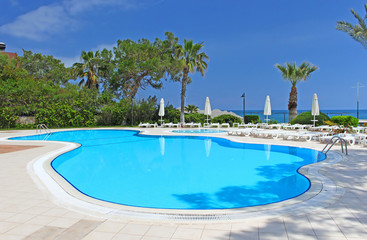 Fototapeta na wymiar Swimming pool area near Mediterranean Sea in Antalya, Turkey
