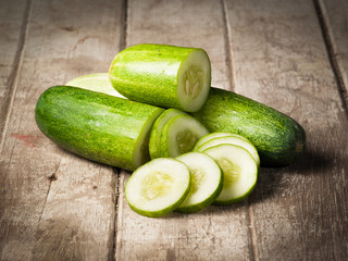 cucumber slices on wooden background © showcake