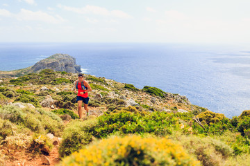 Happy trail running man in beautiful mountains