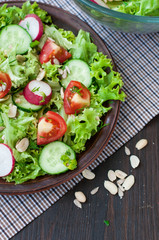 Tomato and cucumber salad with lettuce leafes