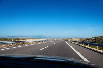 Highway through spanish countryside seen from passengers seat