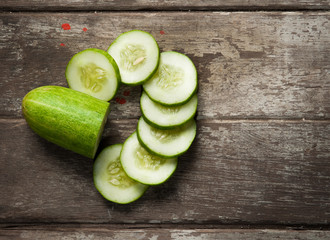 cucumber slices on wooden background © showcake