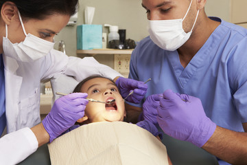 Young Girl Having Check Up At Dentists Surgery