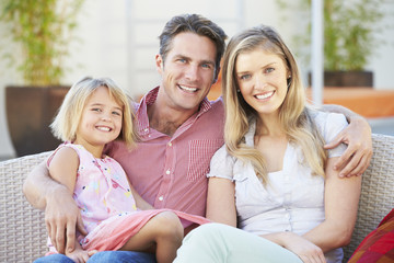 Naklejka premium Family Sitting On Garden Seat Together