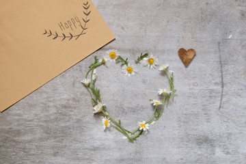Daisy love symbol on old wooden background