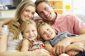 Family Relaxing On Sofa Together