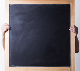 woman holding blank chalkboard in the hand
