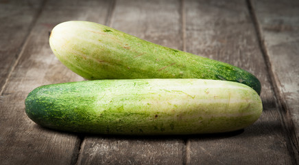 cucumber slices on wooden background
