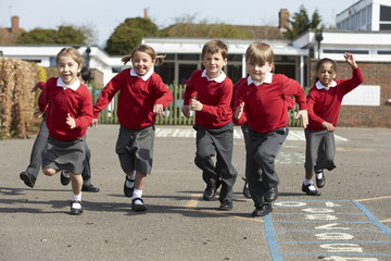 Elementary School Pupils Running In Playground - obrazy, fototapety, plakaty
