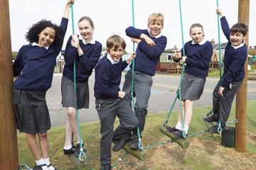 Portrait Of Elementary School Pupils On Climbing Equipment