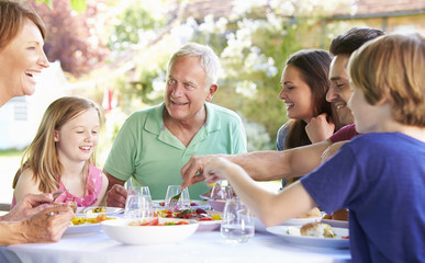 Multi Generation Family Enjoying Outdoor Meal Together