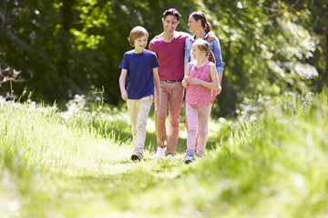 Fototapeta premium Family Walking Through Summer Countryside
