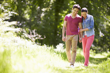 Fototapeta premium Young Couple Walking In Summer Countryside