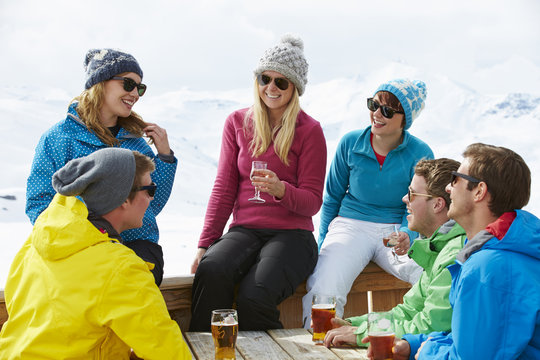 Group Of Friends Enjoying Drink In Bar At Ski Resort