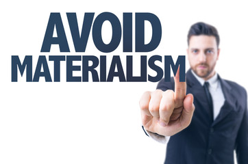 Business man pointing the text: Avoid Materialism