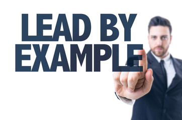 Business man pointing the text: Lead By Example