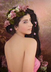 Naklejka premium Young girl with long hair, with wreath of lilac on his head