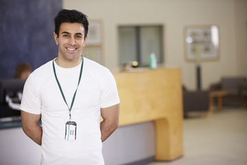 Portrait Of Male Physiotherapist In Hospital Reception