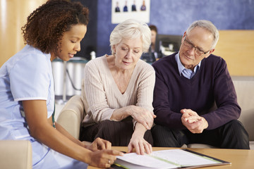Fototapeta premium Senior Couple Meeting With Nurse In Hospital