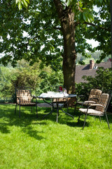 beautiful garden with white table and chair