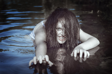 Young beautiful drowned ghost woman in the water