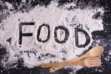 The word "food" written in flour with kitchen accessories