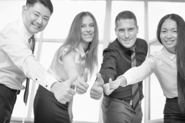 Fototapeta na wymiar Multiracial successful business people with thumbs up gesture