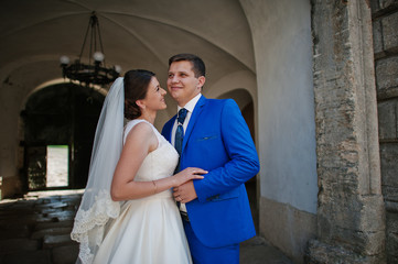 Young wedding couple on background old castle