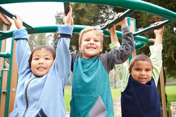 Three Young Boys On Climbing Frame In Playground - Powered by Adobe