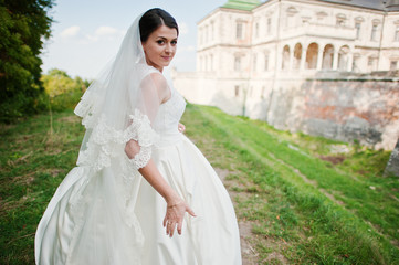 Fototapeta premium Young wedding couple on background old castle