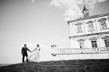 Young wedding couple on background old castle