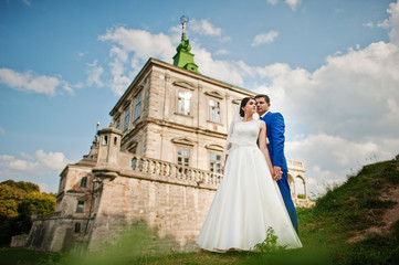 Young wedding couple on background old castle