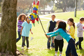 Children Hitting Pinata At Birthday Party