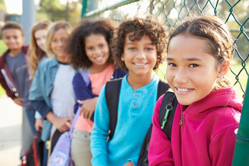 Group Of Young Children Hanging Out In Playground