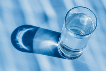 Glass of water on a blue background