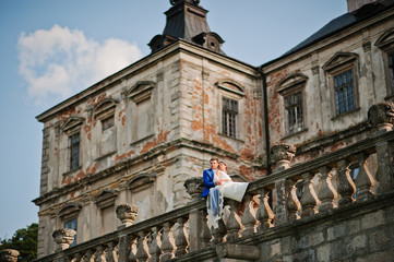 Fototapeta premium Young wedding couple on background old castle