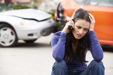 Obraz na płótnie Canvas Female Driver Making Phone Call After Traffic Accident