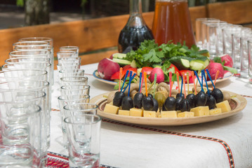 Row of wineglasses and plate with canapes