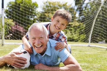 Portrait Of Grandfather And Grandson With Football