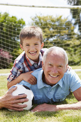 Fototapeta na wymiar Portrait Of Grandfather And Grandson With Football