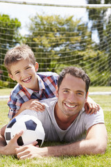 Portrait Of Father And Son With Football