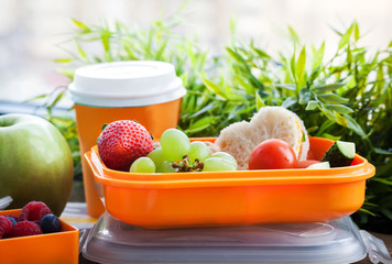 Lunch box for kids with sandwich, cookies, fresh veggies and fruits