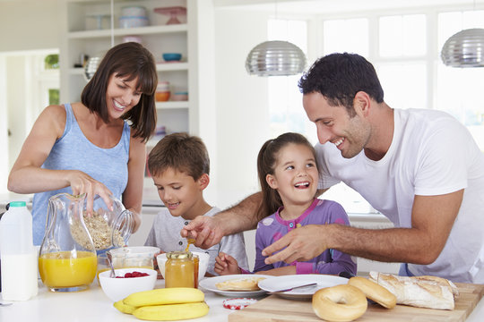 Family Making Breakfast In Kitchen Together