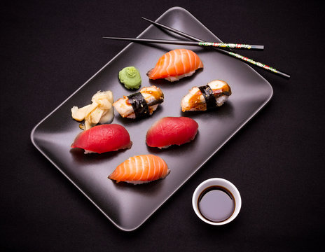 Eel, salmon and tuna sushi with chopsticks