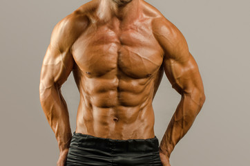 Strong bodybuilder with six pack.Strong bodybuilder man with perfect abs, shoulders,biceps, triceps...