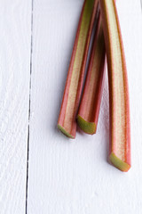 Rhubarb on white wooden table.