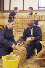 Teacher Helping Students Training To Be Builders