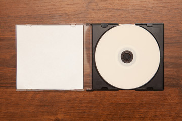 DVD drive in the box on a wooden background. Mock-up for branding identity.